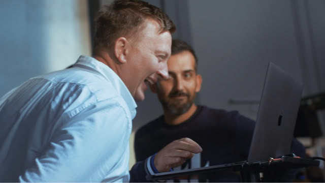 Reviewing footage on a laptop with a colleague